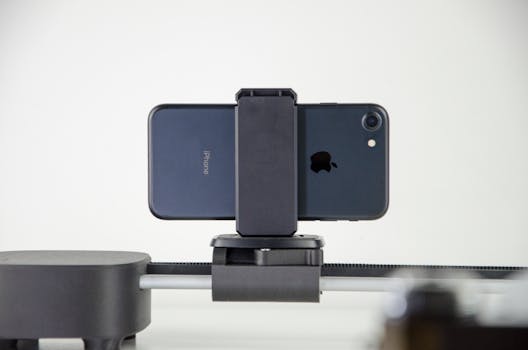 A close-up image of a smartphone mounted on a slider, ideal for video production and cinematic capturing.