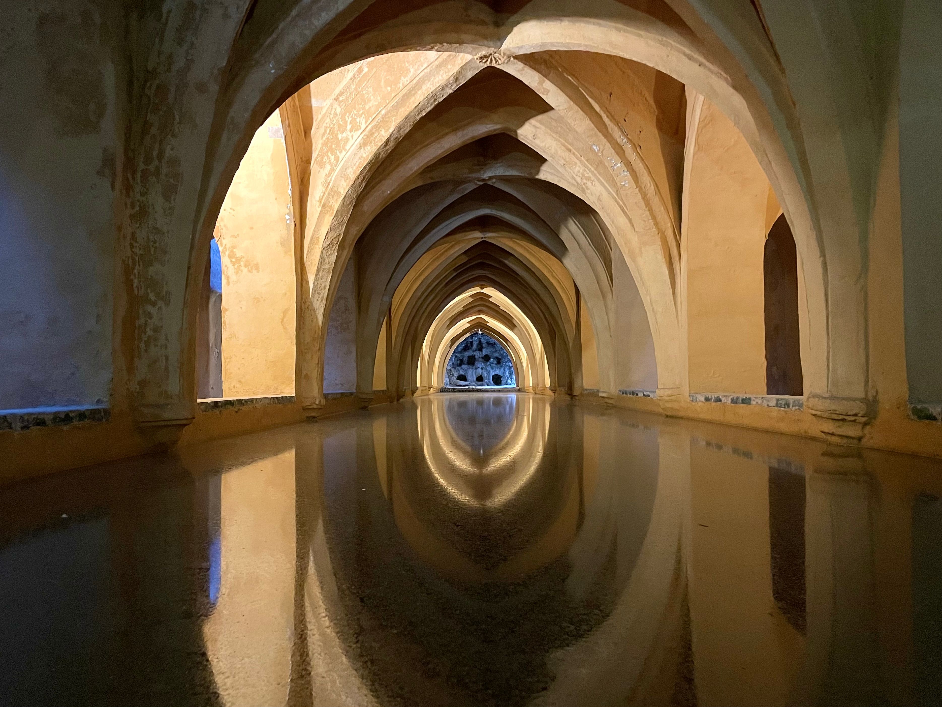 Stunning arches and reflections in the historic Baths of Dona Maria de Padilla in Spain.