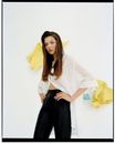 Fashion Model Posing in Front of Paper Glued to Wall