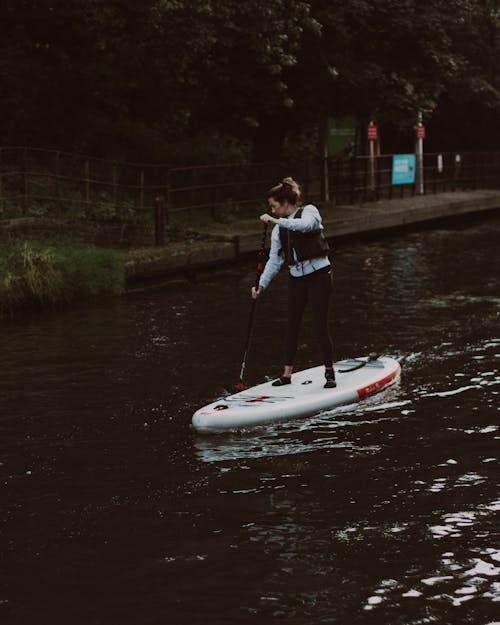 A Woman Standing on a Paddle Board