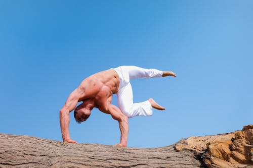 Free Man Wearing White Pants Under Blue Sky Stock Photo