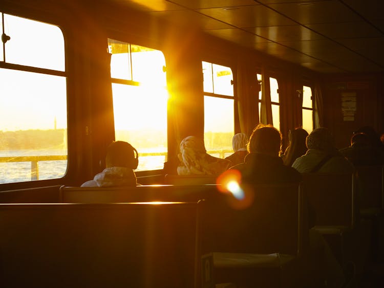 People Riding Train At Sunset