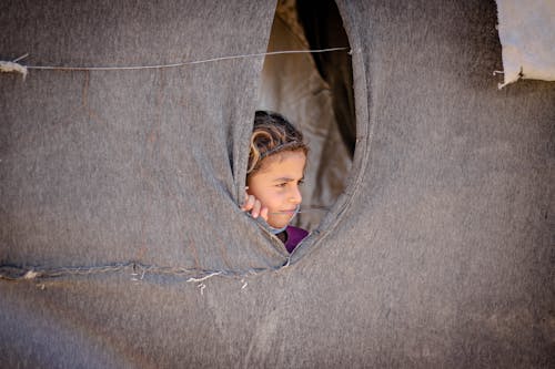 A Child Peeping in a Tent