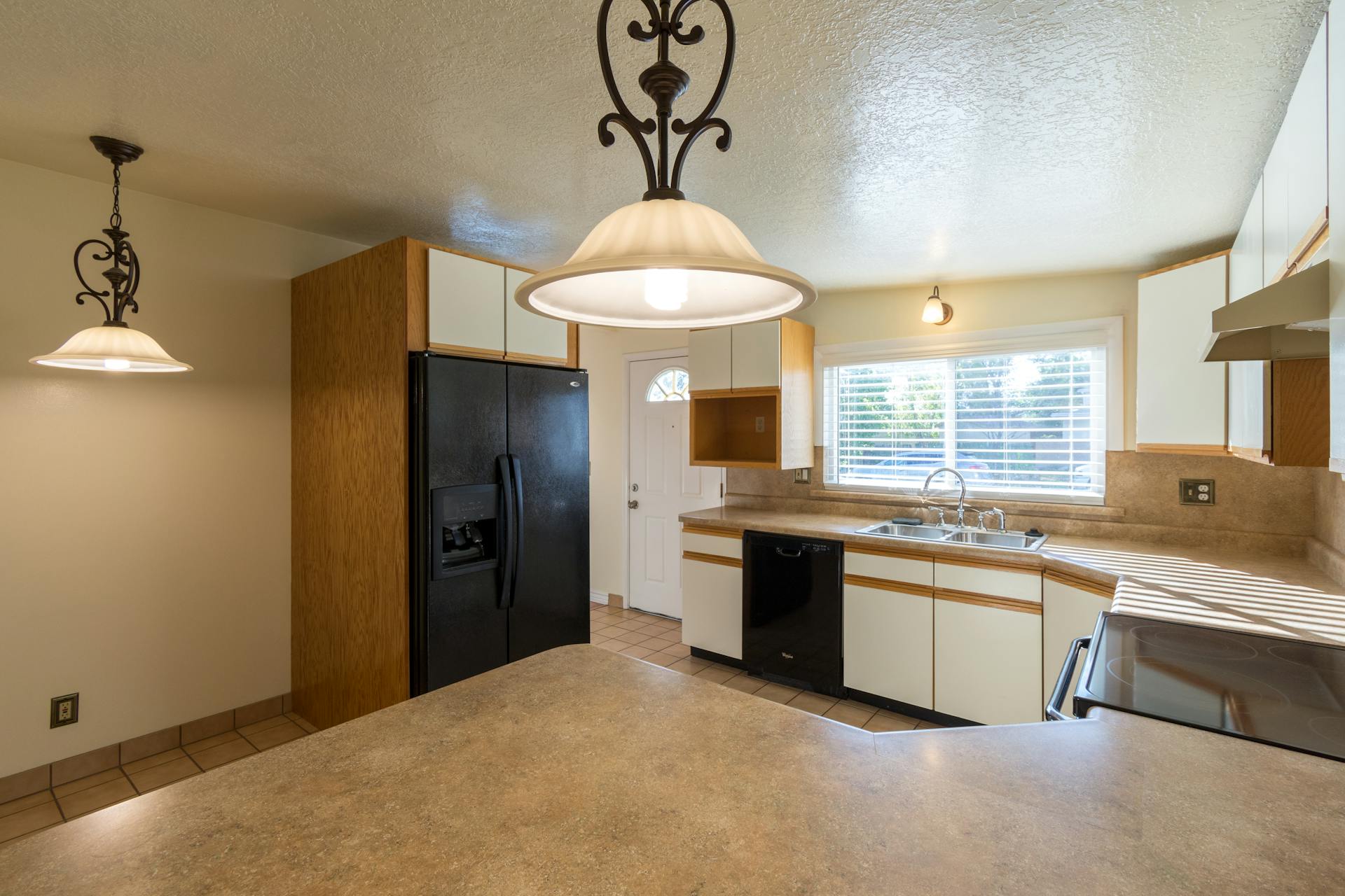 A brightly lit modern kitchen featuring sleek appliances and ample counter space.