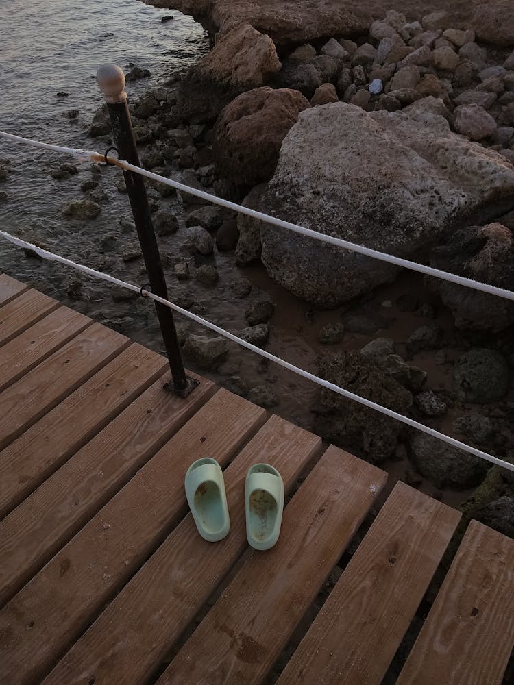 Pair Of Slippers On Wooden Boardwalk