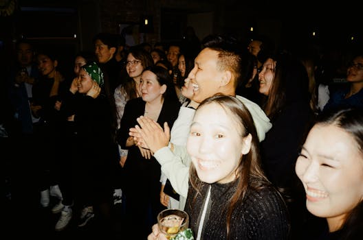 A diverse and happy crowd enjoying a lively night indoors, perfect for party themes.