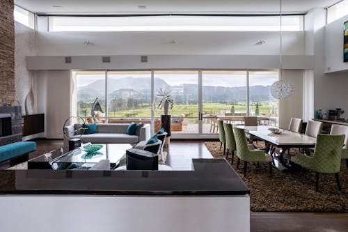 White and Black Dining Table and Green Chairs