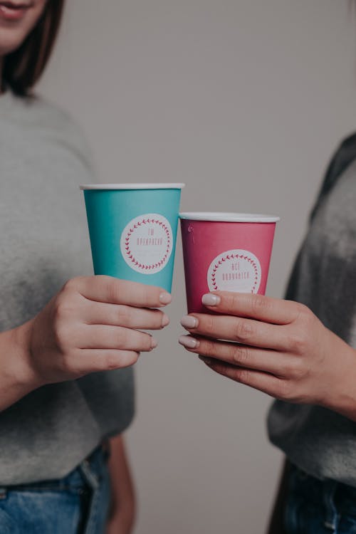 Close up on Paper Cups in Womens Hands