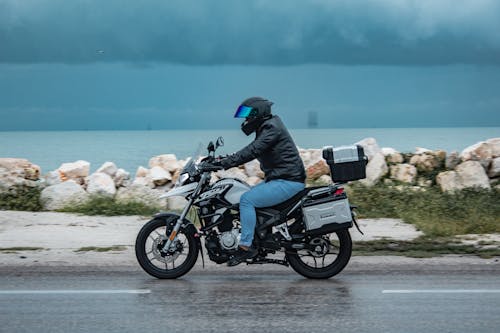 Man Wearing Black Jacket Riding a Motorcycle