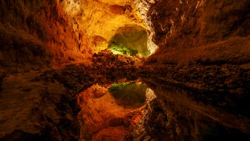 Free Explore the breathtaking reflections inside a volcanic cave in Spain's natural wonder. Stock Photo