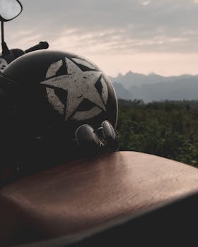 Close-up of a vintage motorcycle helmet in scenic Vietnam with a mountainous backdrop.