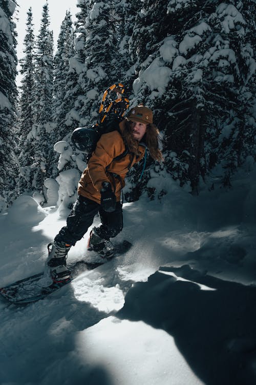 Man Snowboarding in Mountains 