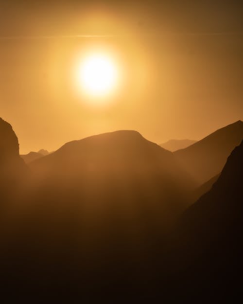 A Silhouette of Mountain Top Under The Sun 