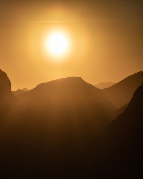 Free Capture of a breathtaking mountain landscape silhouette during sunrise, highlighting golden peaks. Stock Photo