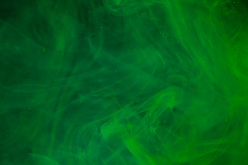 Dynamic abstract image featuring green smoke patterns on a dark background, ideal for creative designs.