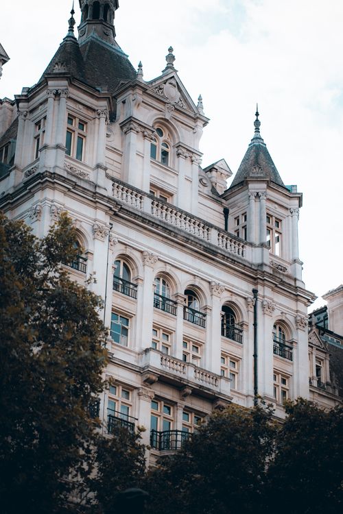 Free Stunning architectural facade of Whitehall Court surrounded by trees in Central London. Stock Photo