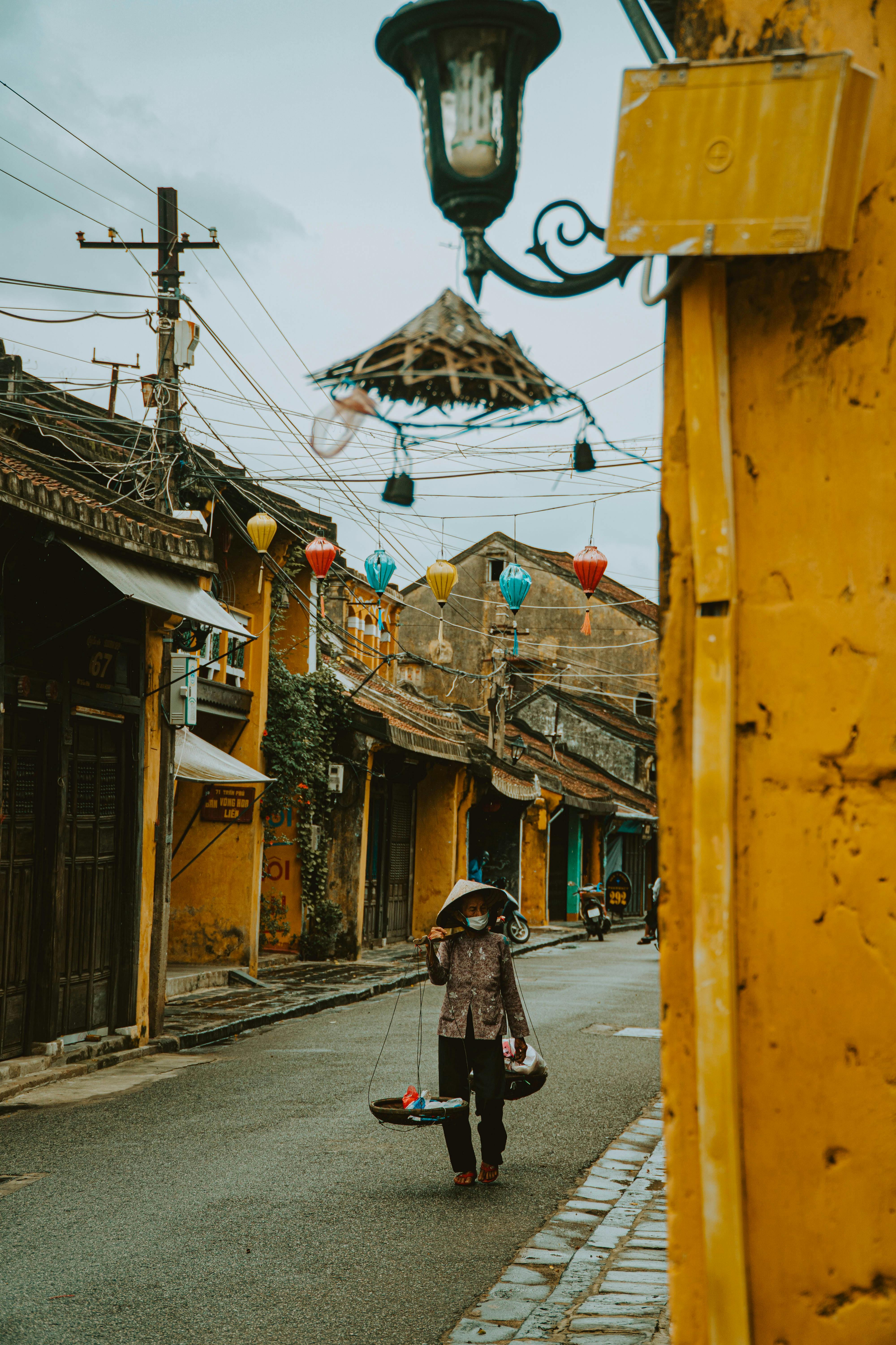 a vendor wearing face mask carrying baskets