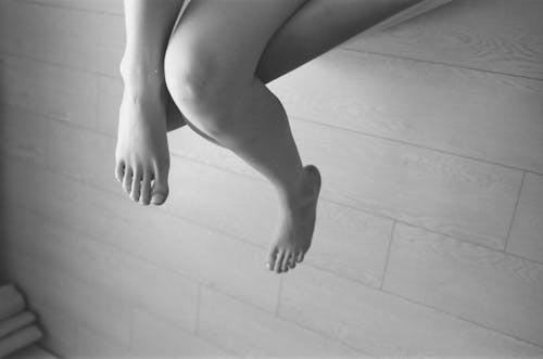 Grayscale Photo of a Barefooted Person