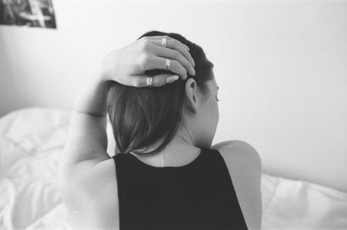 Back View of a Woman with Her Hand on Her Head