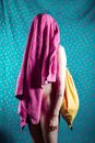 A Person Carrying Drawstring Bag Covering His Body and Face Using a Towel