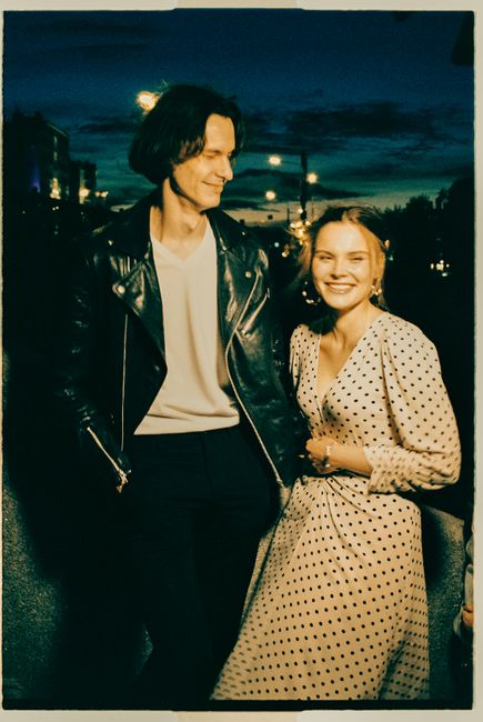 A fashionable couple enjoys a warm evening in Moscow, radiating happiness and style.