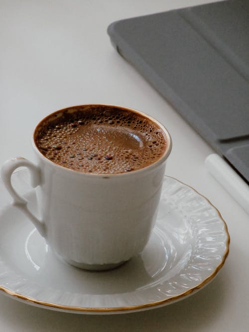 Close-Up Photo of a Cup of Coffee on a White Saucer