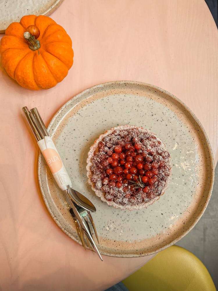 Overhead View Of Pie With Red Berries And Pumpkin