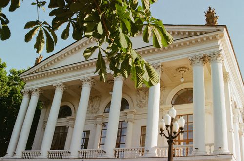 Free Stunning neoclassical building featuring ornate columns and lush greenery in Sevastopol. Stock Photo