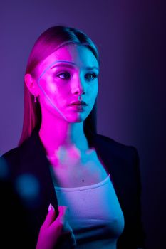 A captivating portrait of a woman in neon pink and blue lighting, showcasing modern aesthetics.