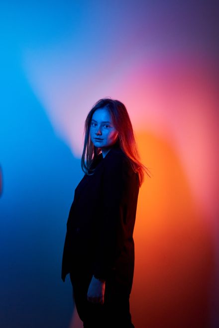 Portrait lit by blue and red studio gels — photo by Roma Durkin on Pexels