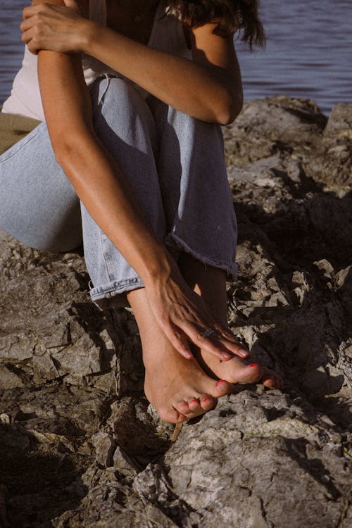 Woman Sitting on Rocks