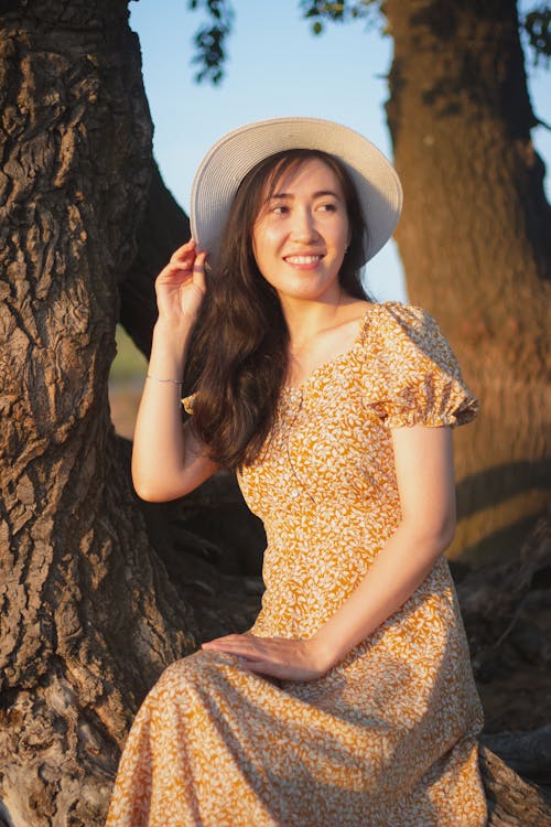 Woman in Yellow Dress Wearing a Hat