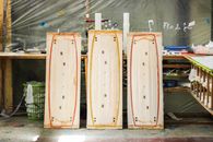 Handcrafted wooden surfboards in a Valle del Cauca workshop, showcasing craftsmanship.