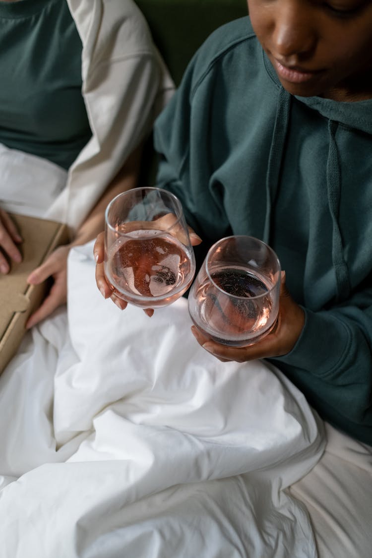 Woman Holding Two Drinking Glasses