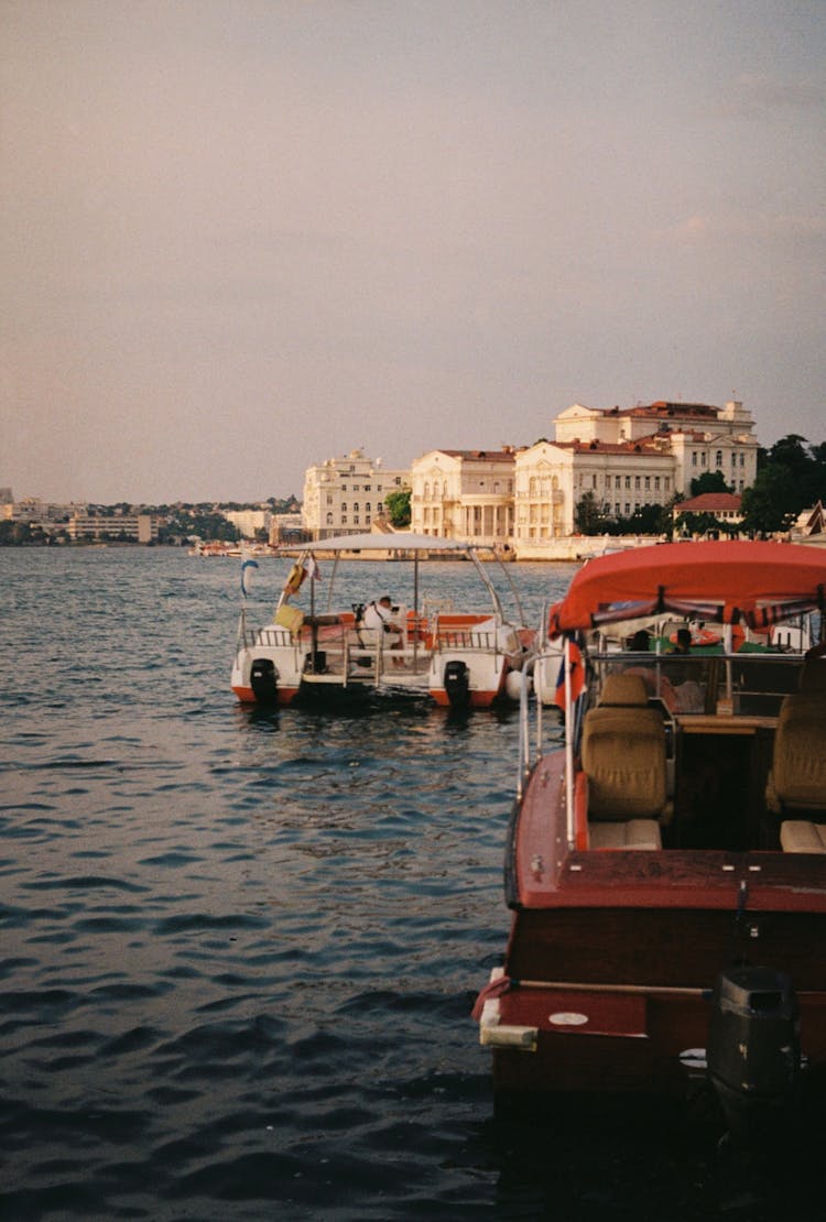 Small Pedal Boats On Lake By Mansion