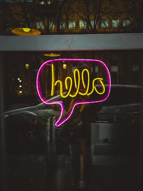 Photo of a Purple and Yellow Neon Signage