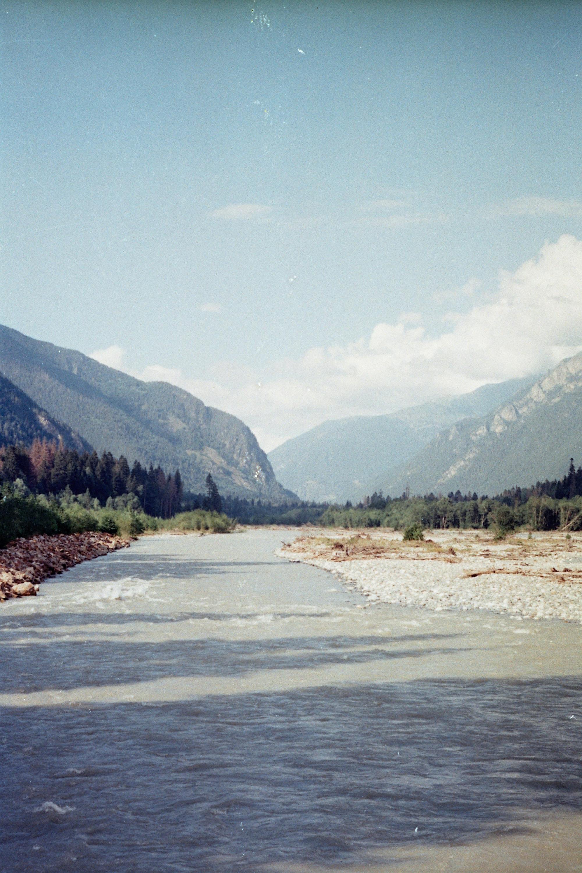 Peaceful river flowing through mountains in Teberda, Russia.
