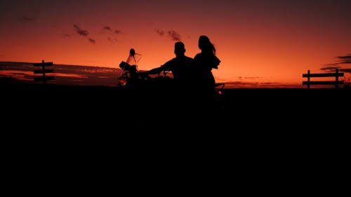Couple on Motorcycle at Sunset