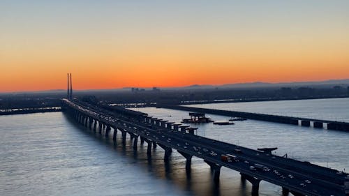Time Lapse of Sunrise over Bridge in City