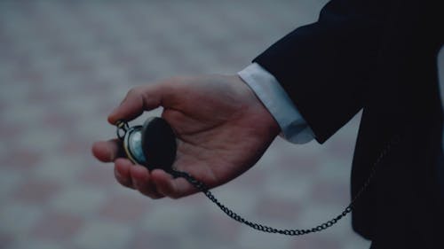 Hand of Man Holding Pocket Watch