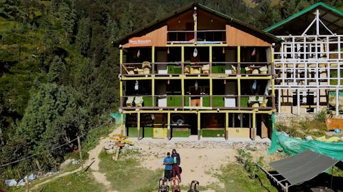 An Aerial Footage of Lodges with a Forest Background