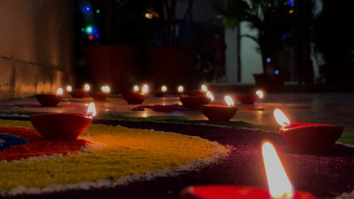 Group of Lit Candles on Floor