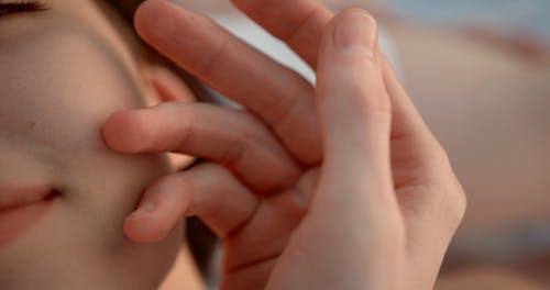 Close Up Video of Person Touching a Woman's Face