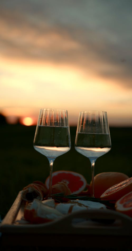 A Wine Glasses and Fruits on the Wooden Tray