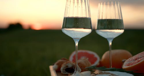 A Wine Glasses and Fruits on the Field