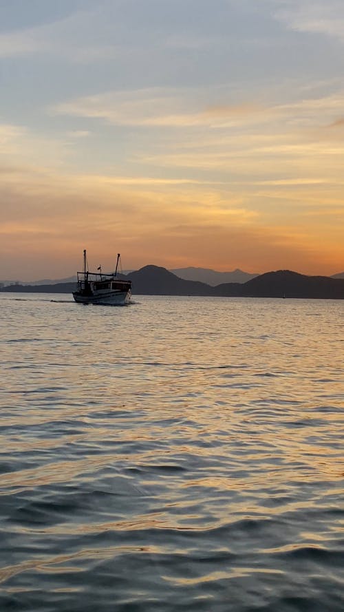 Small Ship Sailing during Sunset