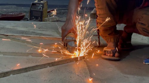 Man Cutting Metal With Angle Grinder