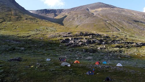 Drone Footage of People Camping near the Mountain 