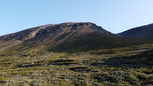 A Group of People Walking in a Mountain Landscape