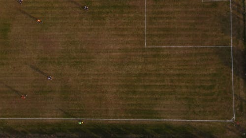 A Birds Eye View of People Running on a Football Field